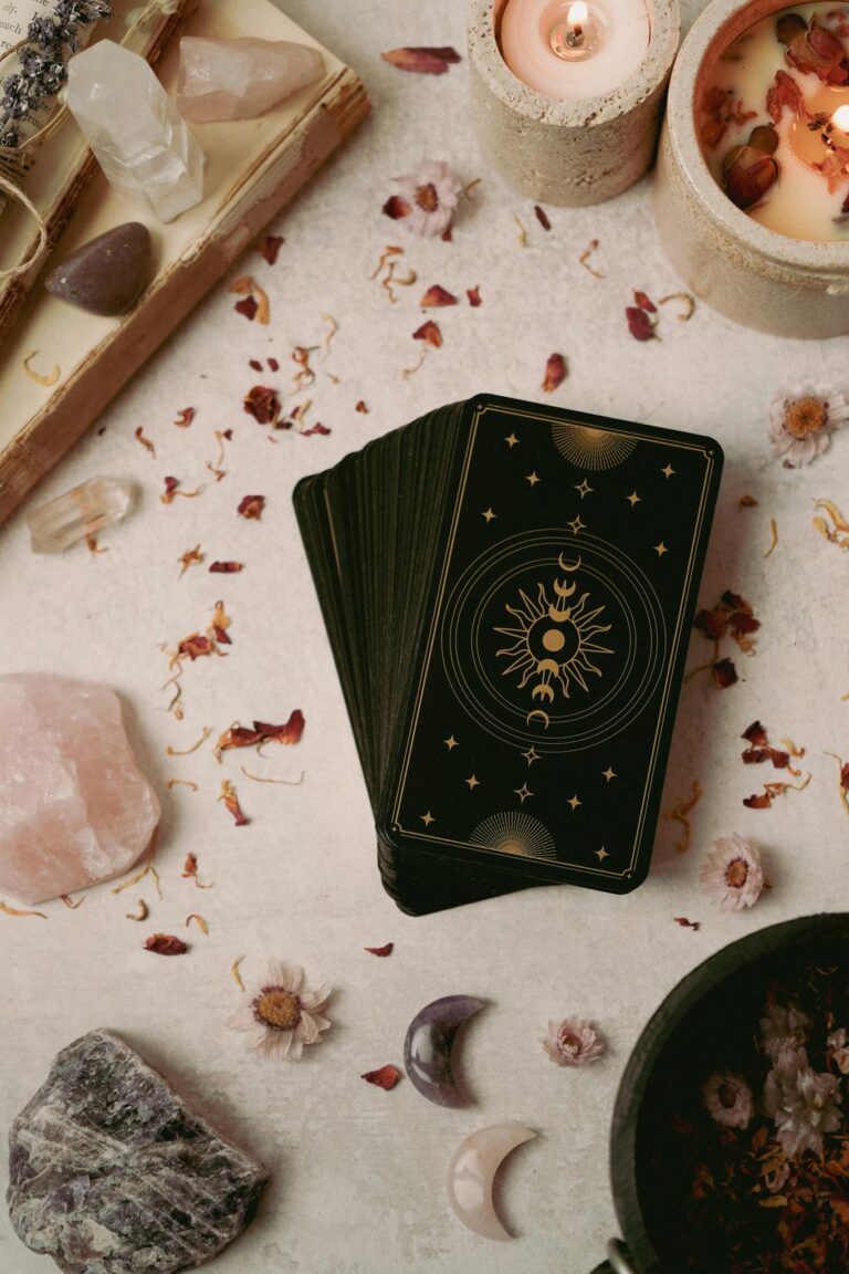 Aesthetic arrangement with tarot cards, healing crystals, and candles for spiritual practices.